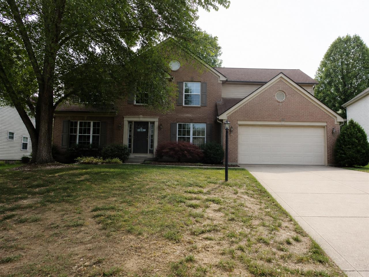 The same Indiana home with a patchy, weedy lawn before Meadow treatment